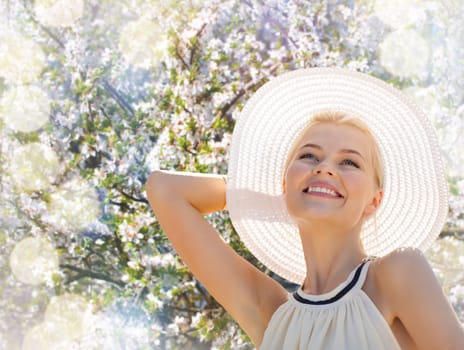 fashion, happiness and lifestyle concept - beautiful woman in hat enjoying summer outdoors