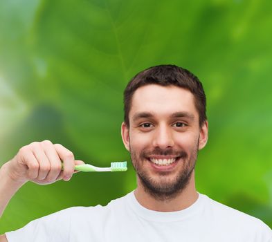 health and beauty concept - smiling young man with toothbrush