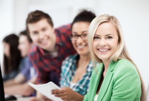 education, technology and internet - students with computer studying at school