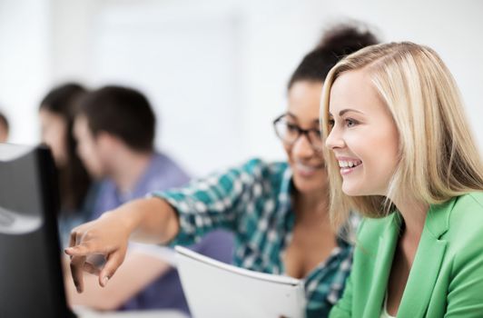 education, technology and internet - students with computer studying at school