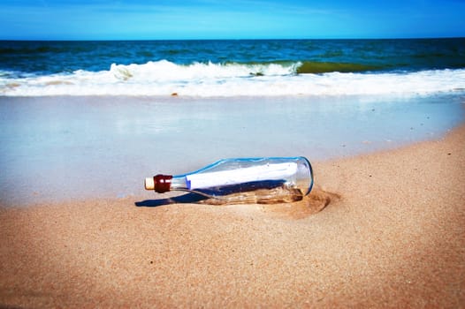 Bottle with a message. Beach and ocean.