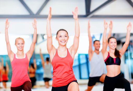 fitness, sport, training, gym and lifestyle concept - group of smiling people exercising in the gym