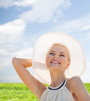 fashion, happiness and lifestyle concept - beautiful woman in hat enjoying summer outdoors