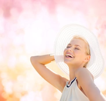 fashion, happiness and lifestyle concept - beautiful woman in hat enjoying summer outdoors