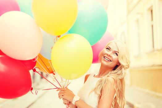 summer holidays, celebration and lifestyle concept - beautiful woman with colorful balloons in the city