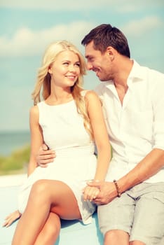 summer holidays and dating concept - smiling couple at sea side