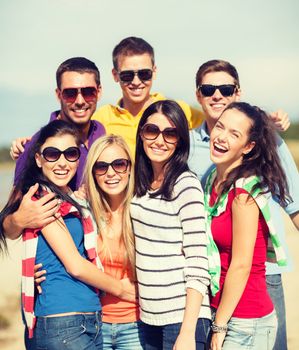 summer, holidays, vacation, happy people concept - group of friends having fun on the beach