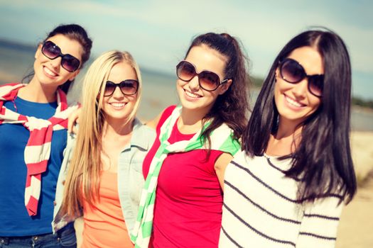 summer, holidays, vacation, happy people concept - beautiful teenage girls or young women having fun on the beach