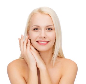 health and beauty concept - face and hands of happy woman
