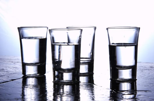Alcohol conceptual image. Glasses of pure vodka.