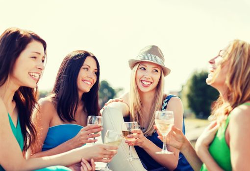 summer holidays and vacation - girls with champagne glasses on boat or yacht