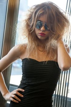 fashion and lifestyle concept - beautiful young woman in sunglasses