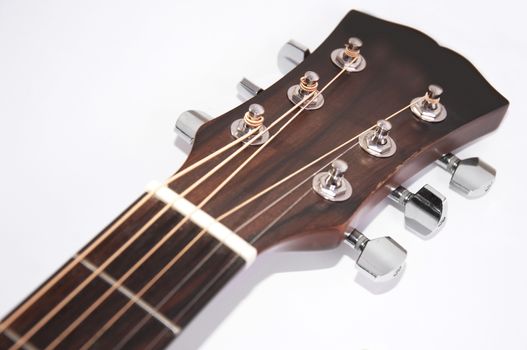 Music conceptual image. Close up of acoustic guitar neck on white background..