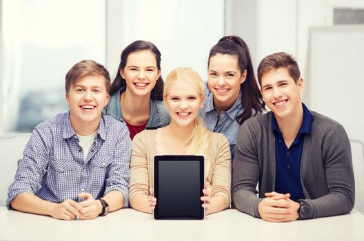 education, technology, advertisement and internet concept - group of smiling students with blank black tablet pc screen