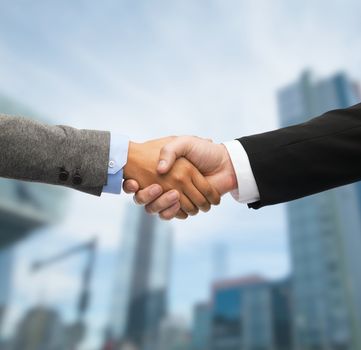 business and office concept - businessman and businesswoman shaking hands