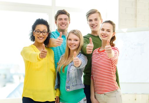 education and school concept - five smiling showing thumbs up at school