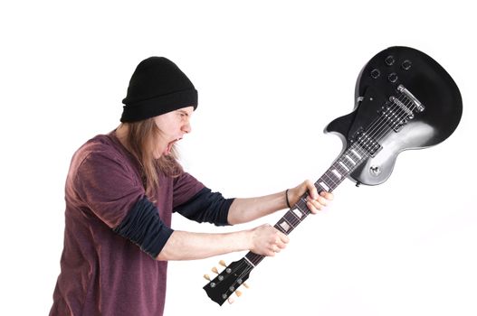 Rock musician. Aggressive mad rock guitarist destroys his guitar.