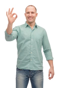 happiness, gesture and people concept - smiling man showing ok-sign
