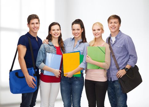 education and people concept - group of smiling students standing