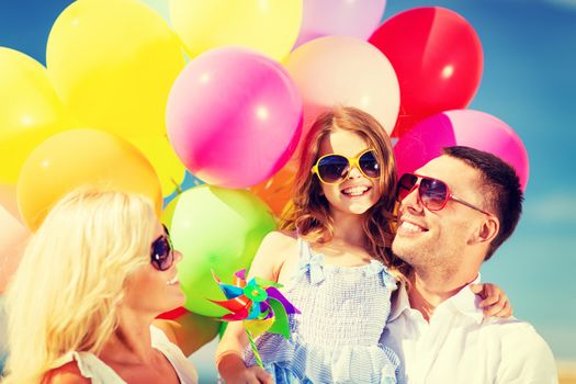 summer holidays, celebration, children and people concept - family with colorful balloons