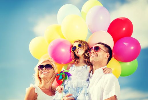 summer holidays, celebration, children and people concept - family with colorful balloons