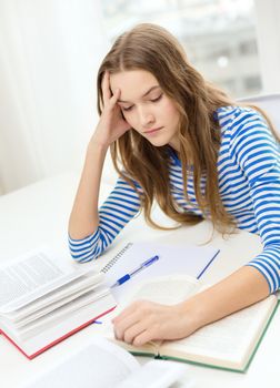 education and home concept - stressed student girl with books