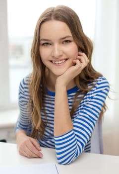 education and home concept - smiling teenage girl with notebook at home