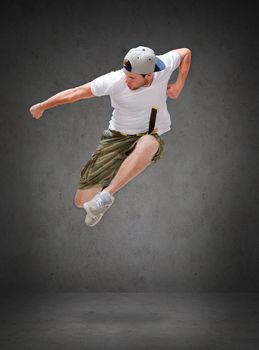 dancing, happiness and people concept - male dancer jumping in the air