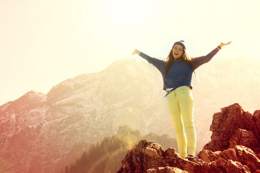 Happy teenage girl feel freedom in mountains scenery.