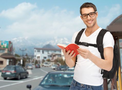 travel, vacation and education concept - travelling student with backpack and book