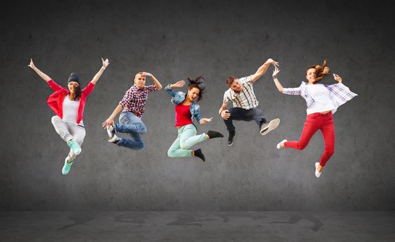 summer, sport, dancing and teenage lifestyle concept - group of teenagers jumping