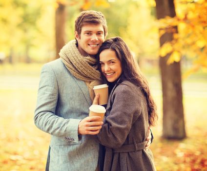 holidays, love, travel, relationship and dating concept - romantic couple in the autumn park