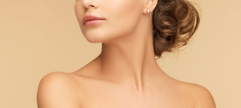 beauty and jewelery concept - beautiful woman with pearl earrings