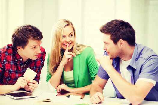 education concept - group of students gossiping at school