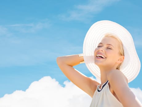 fashion, happiness and lifestyle concept - beautiful woman in hat enjoying summer outdoors