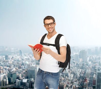 travel, vacation and education concept - travelling student with backpack and book