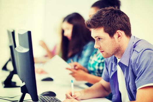 education concept - student with computer studying at school