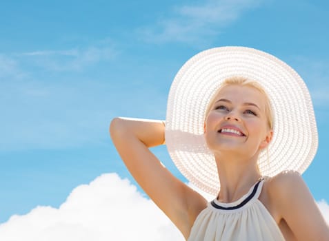 fashion, happiness and lifestyle concept - beautiful woman in hat enjoying summer outdoors