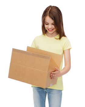 post office, transportation and people concept - smiling little girl looking into open cardboard box