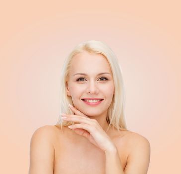 health and beauty concept - face and hands of beautiful woman