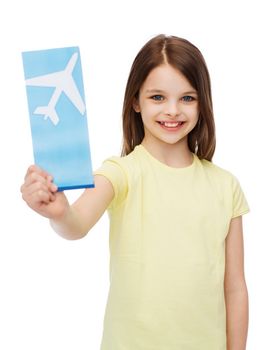 travel, holiday, vacation, childhood and transportation concept - smiling little girl with airplane ticket