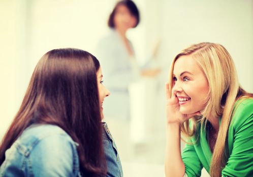 education concept - student girls gossiping at school