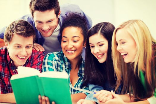 education concept - group of students reading book at school