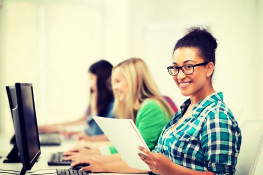 education, technology and internet - african student with computer studying at school