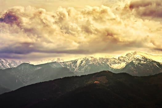 Big dark cloudscape over mountains. Nature conceptual image.