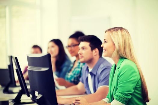 education, technology and internet - students with computers studying at school