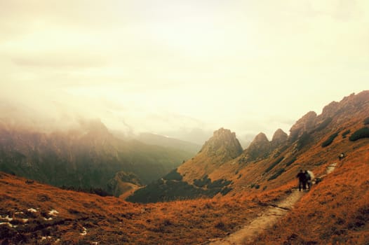 Tourists on the path in mountains, climing to the top of Giewont Mountain in Tatra Mountains., Poland.