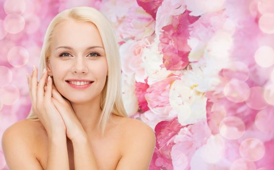 health and beauty concept - face and hands of happy woman