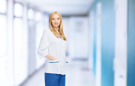 healthcare and medical concept - smiling female doctor or nurse in medical facility