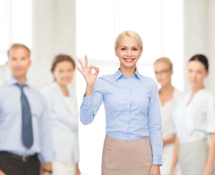 business and education concept - smiling businesswoman showing ok-sign with hand